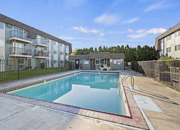 a swimming pool in front of an apartment building
