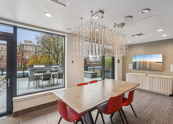 A modern dining room with a large table and chairs.