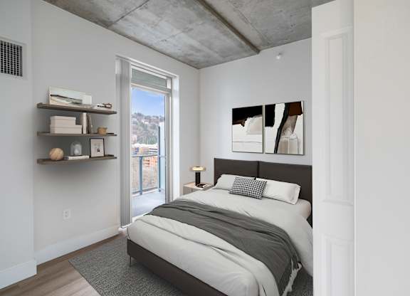 A bedroom with a bed, pillows, and a window.