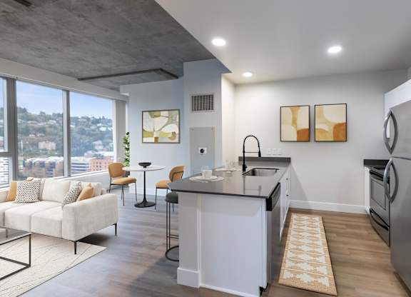 A modern kitchen with a large island and a view of the city.