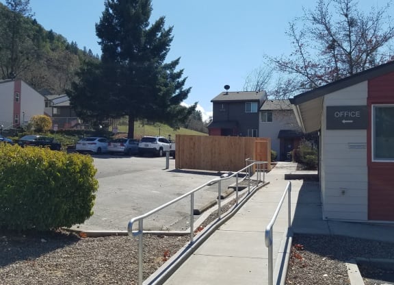 a sidewalk in front of a building with a ramp next to it