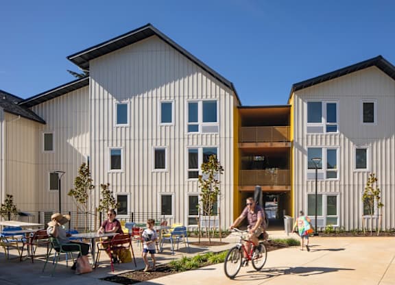 A modern building with a bicycle parked in front.