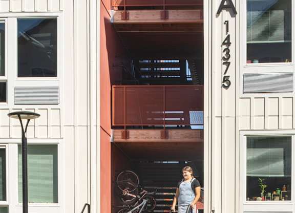 A woman is standing on the stairs of apartment A375.