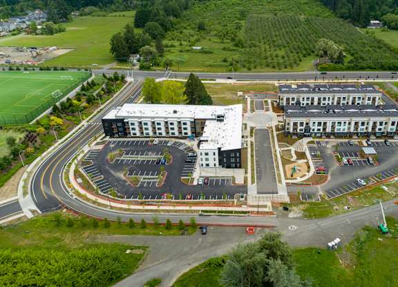 A large building with a parking lot in front of it.