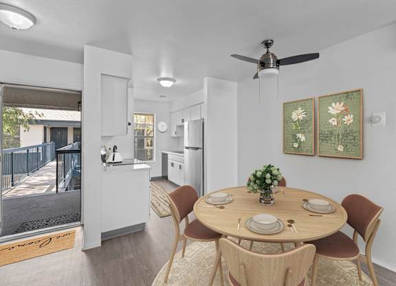 A dining room with a round table and chairs.