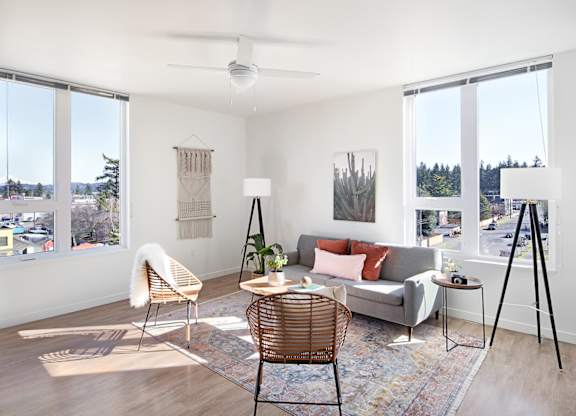 A living room with a grey couch, a chair, and a table.