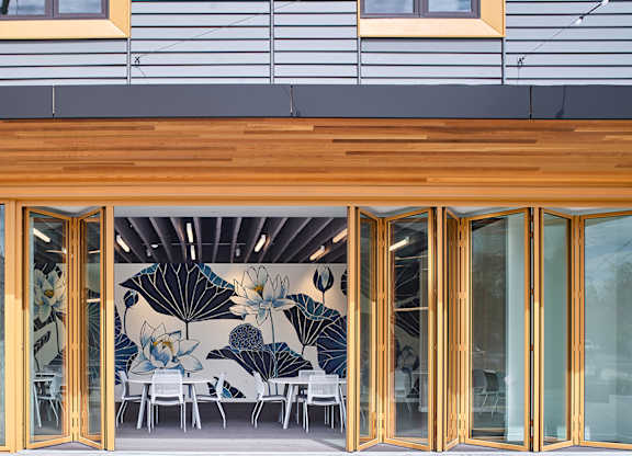 A modern building with a wooden facade and glass doors.