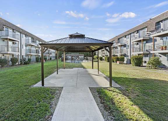 an open gazebo in the middle of an apartment building