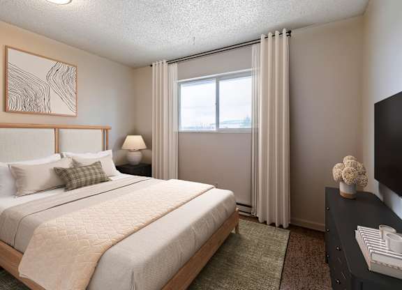 A bedroom with a large bed and a television.