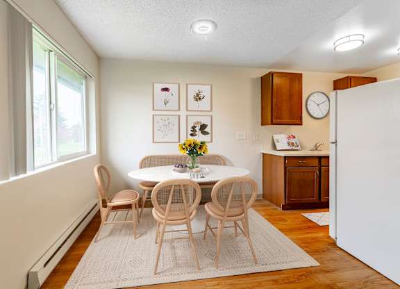 A dining room with a table set for four.