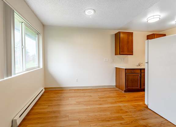 A room with wooden floors and white walls.