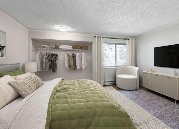 A bedroom with a large bed and a green comforter.