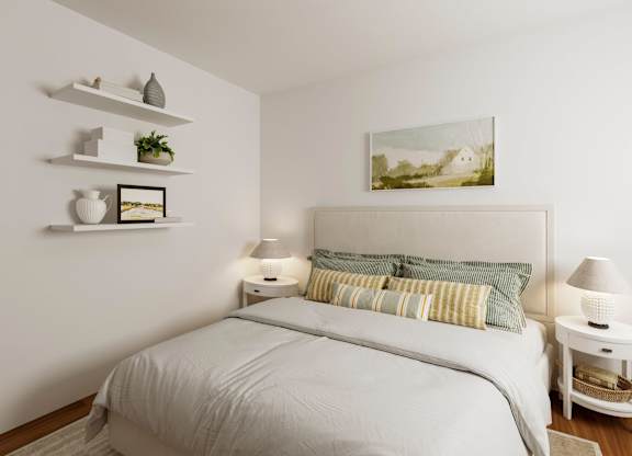 A white bedroom with a large bed and a painting on the wall.