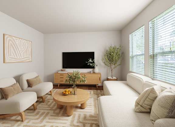 A living room with a white couch, a wooden coffee table, and a flat screen TV.