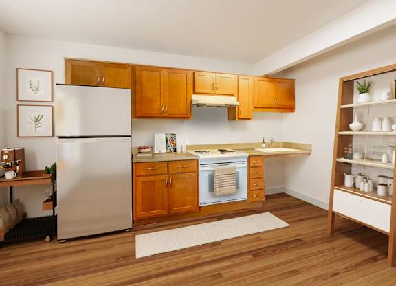 A kitchen with wooden cabinets and a white refrigerator.