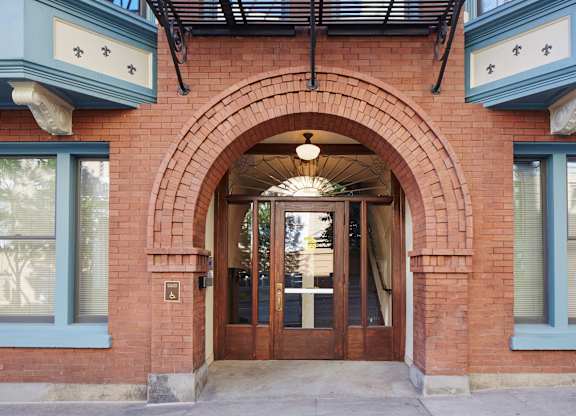 A red brick building with a large arched doorway.