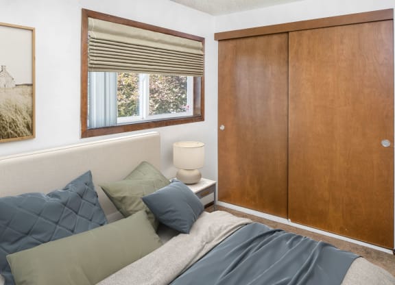a bedroom with a bed and a window