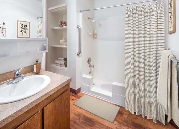 a bathroom with a shower and a sink