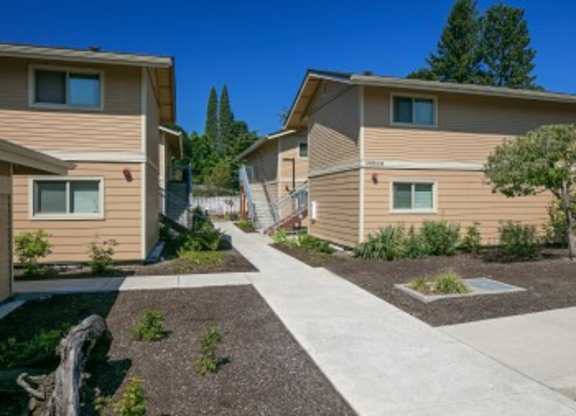 A sunny day at a residential area with houses and a clear blue sky.