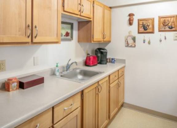 A kitchen with wooden cabinets and a white countertop.
