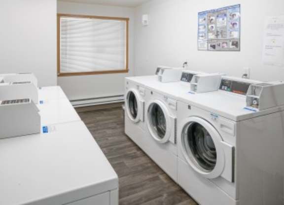 A row of washing machines in a laundromat.