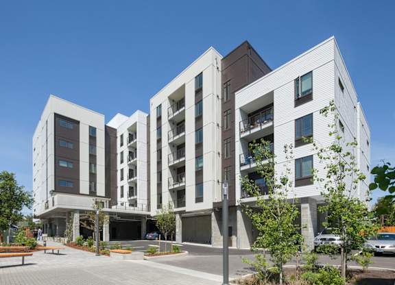 A modern building with a parking lot in front.
