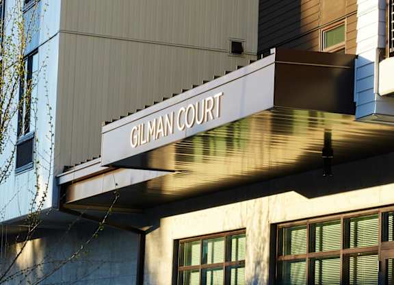 Gilman Court building with a tree in front.