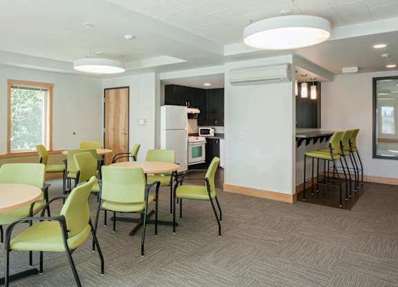 A room with a table and chairs in it.