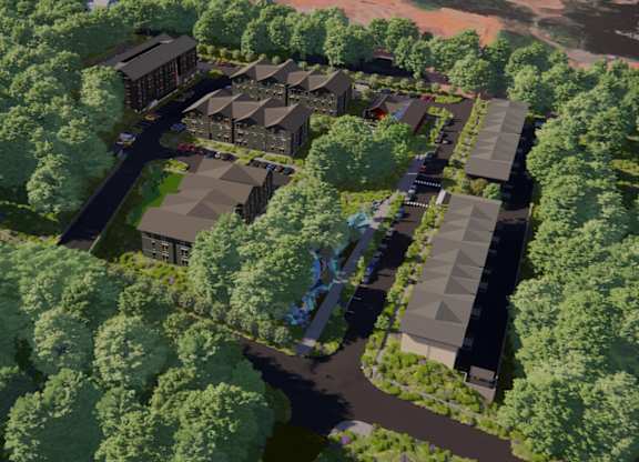 A bird's eye view of a residential area with houses surrounded by trees.