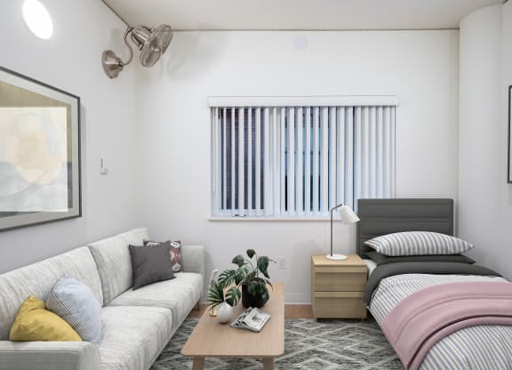 a bedroom with a bed and couch