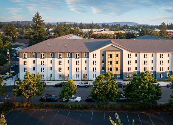 A large building with a parking lot in front of it.