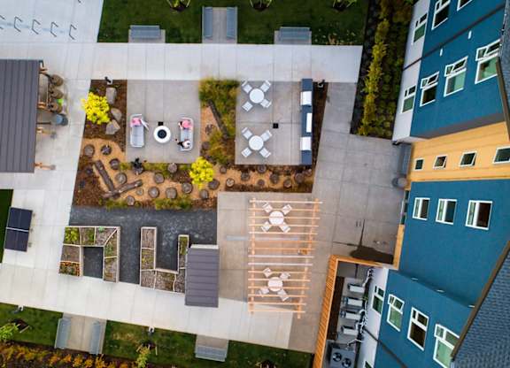 A courtyard with a table and chairs surrounded by buildings.