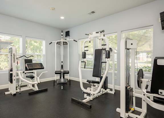 A well-equipped home gym with various exercise machines.