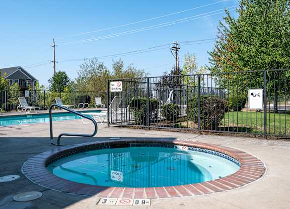 A pool with a sign that says "No Diving" is surrounded by a fence.