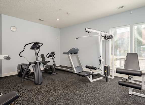A well equipped gym with a variety of exercise equipment.