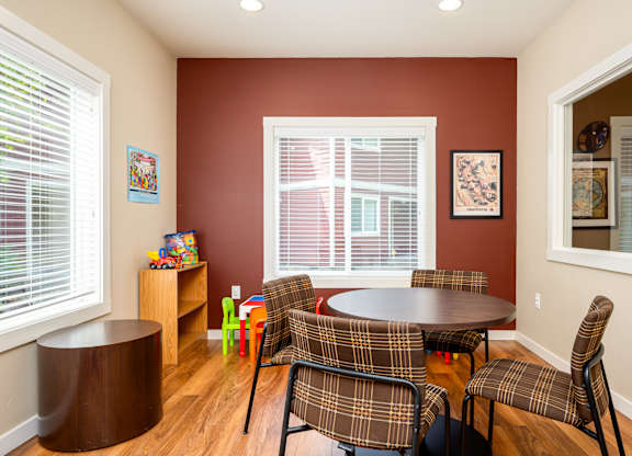 A room with a table and chairs.