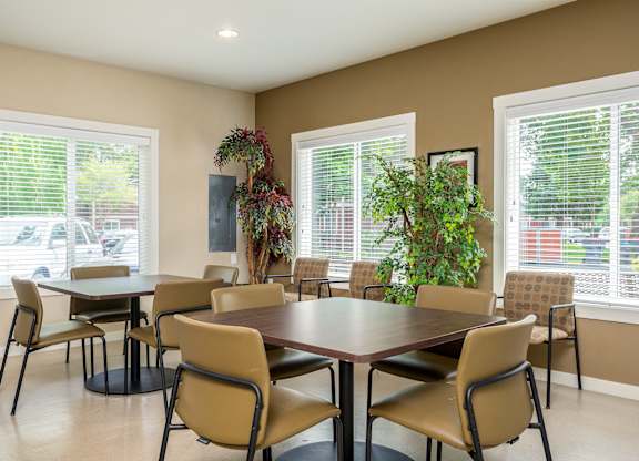 A conference room with a large table surrounded by chairs.