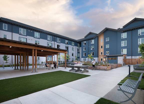 A modern building with a courtyard and seating area.