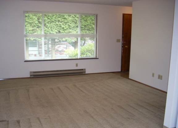 A room with a window and a bench.
