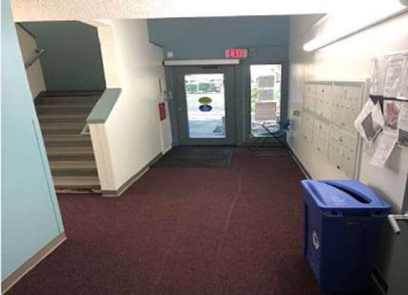 a hallway in a building with a door and stairs