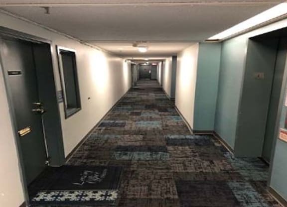 a long hallway with doors in a building