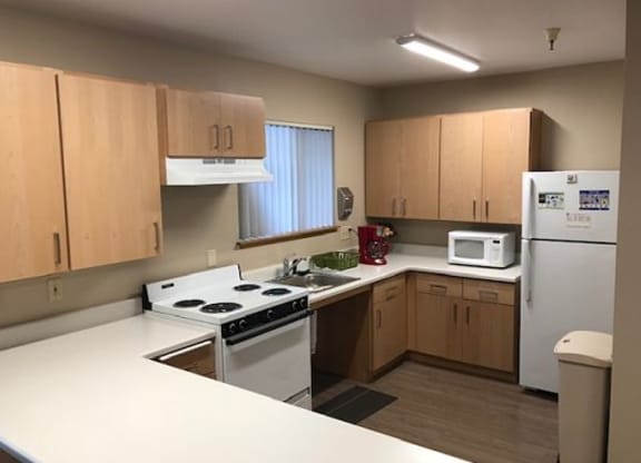a kitchen with white appliances and wooden cabinets