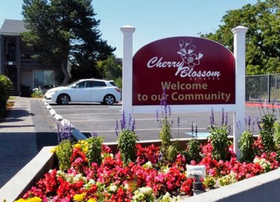 Cherry Blossom Community sign in front of a building.