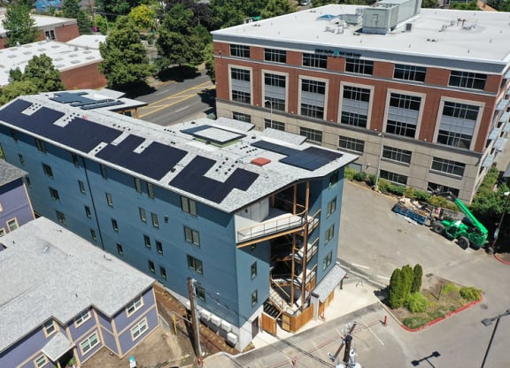 an aerial view of a building with a blue roof