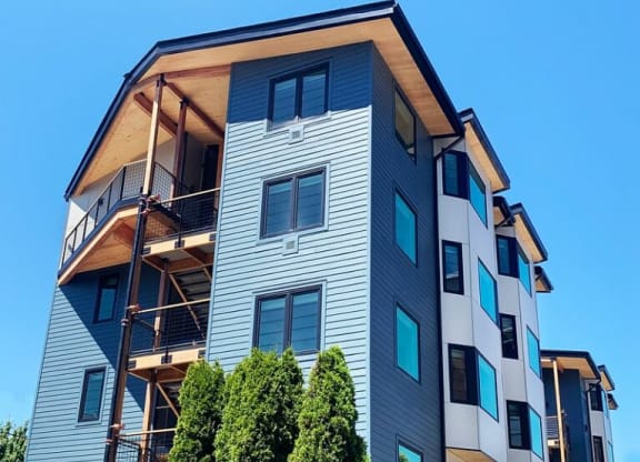a tall apartment building with scaffolding on top of it