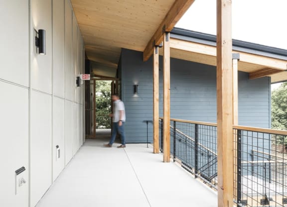 a covered walkway leading to the front door of a house