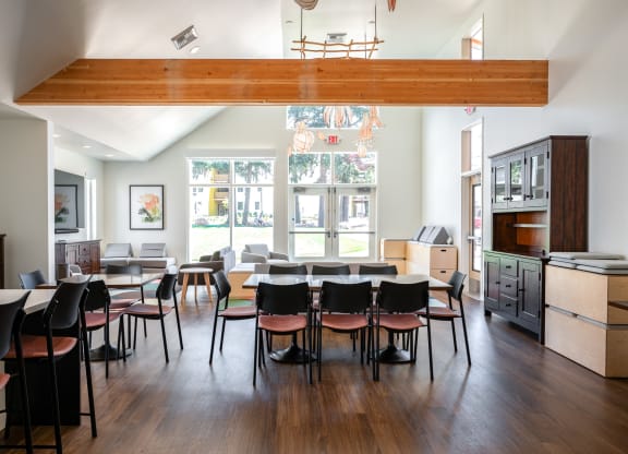 a dining room with tables and chairs and a large window