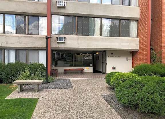 The image shows a building entrance with a sign that reads