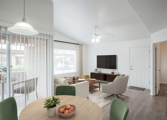 a living room and dining room with a table and chairs
