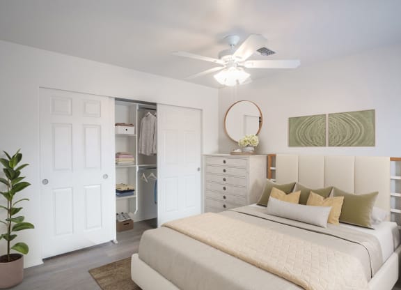 a bedroom with a bed and a ceiling fan